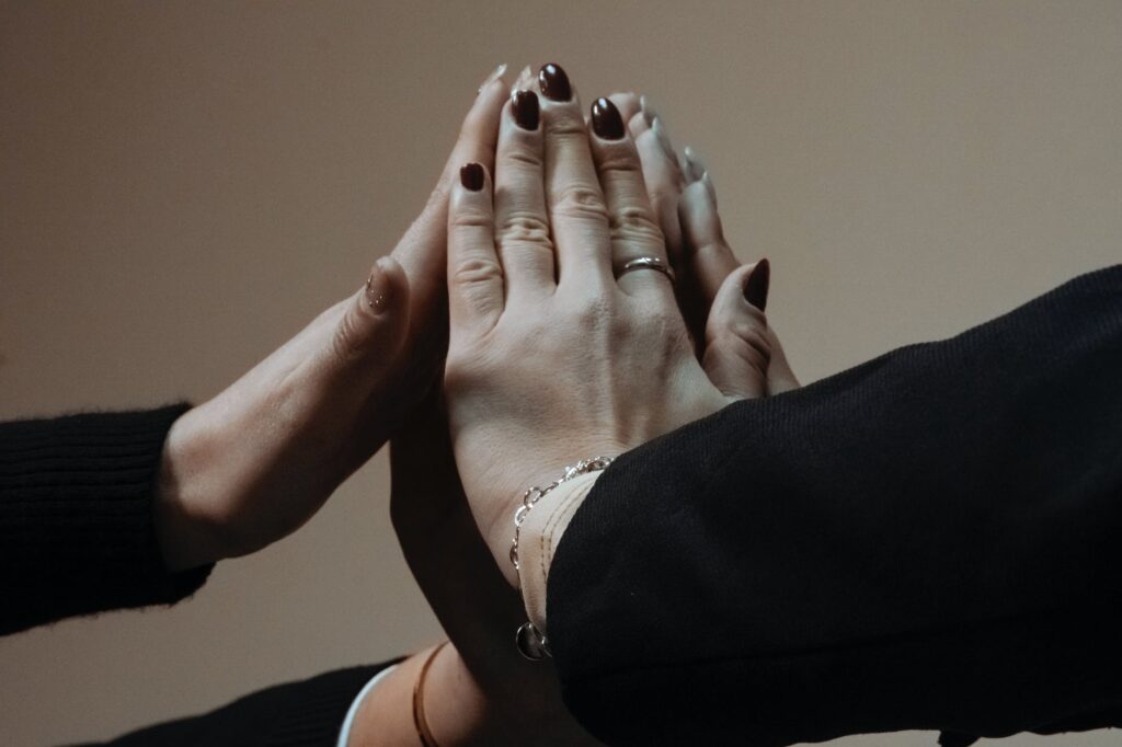 close up on women touching hands with painted nails